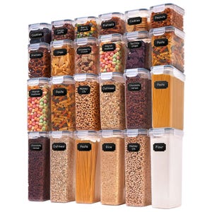 A set of transparent storage containers with various contents like cookies, pretzels, pasta, oatmeal, cereal, and flour, all labeled for easy identification.