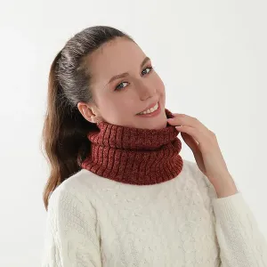 Woman wearing a white cable-knit sweater and a rust-colored turtleneck collar.