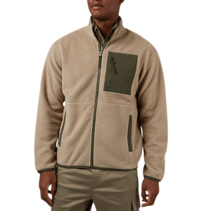 A man is wearing a tan fleece zip-up jacket with a dark green chest pocket and matching green accents. He's paired it with khaki pants.