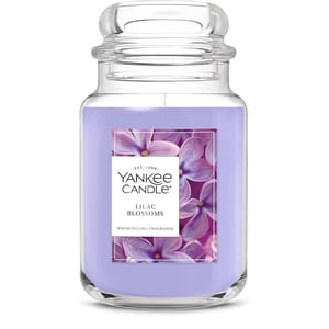Yankee Candle jar in the \“Lilac Blossoms\“ fragrance, featuring a purple wax and floral label.