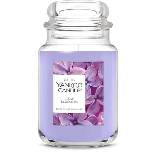 Yankee Candle jar in the \“Lilac Blossoms\“ fragrance, featuring a purple wax and floral label.