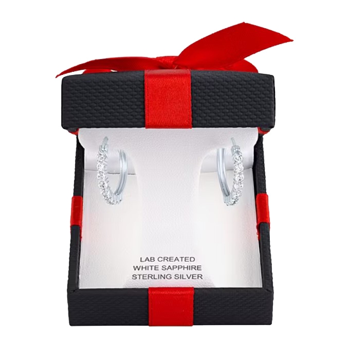 A pair of sterling silver hoop earrings with lab-created white sapphire accents are presented in a black gift box with a red ribbon.