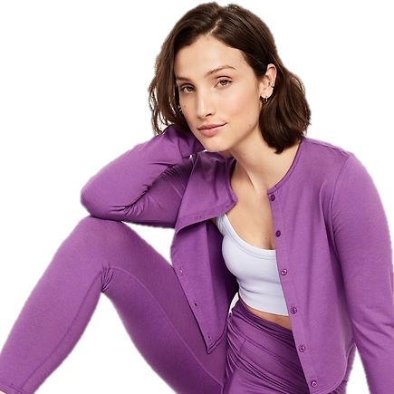 A person is wearing a purple cardigan and matching leggings set, paired with a white crop top.