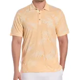 A man is wearing a light orange polo shirt with a subtle palm leaf pattern, paired with white pants.