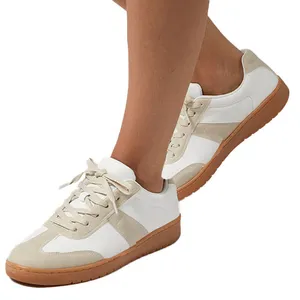 White and beige sneakers with a suede trim and rubber soles, featuring lace-up closure.