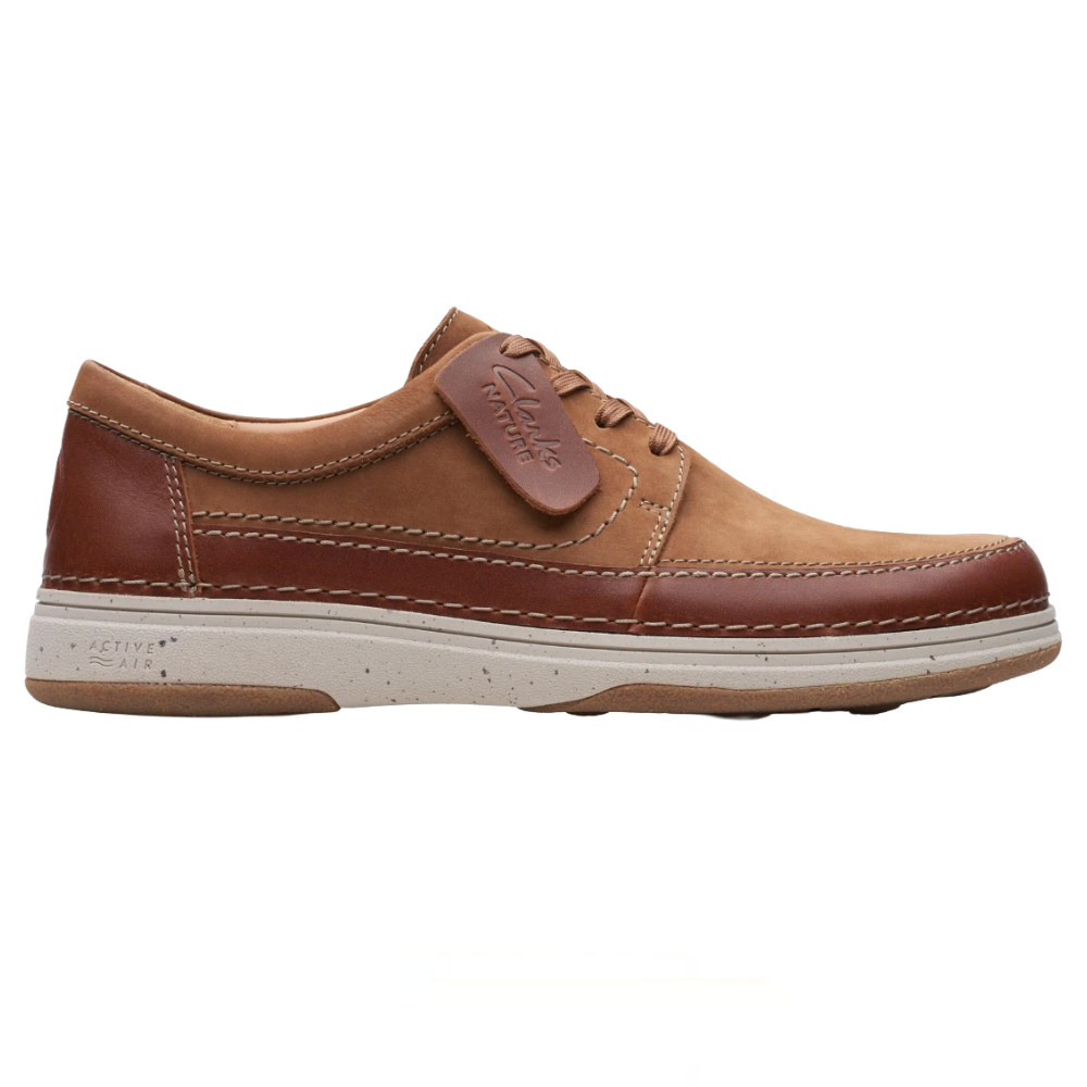 Brown leather casual shoe with lace-up closure, featuring Clarks branding on a tag and a cushioned white sole with \“Active Air\“ technology.