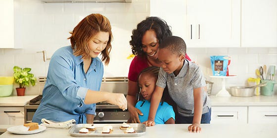 women cooking in the kitchen with children