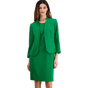 Woman wearing a green knee-length dress with matching three-quarter sleeve blazer, featuring sleek lines and a minimalistic collar.