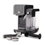 Espresso machine with a milk frother and removable water tank, accompanied by a portafilter, tamper, and interchangeable filter baskets.