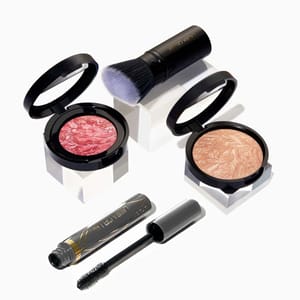 Laura Geller Full Face Kit includes a baked blush, a baked highlighter, a volumizing mascara, and a kabuki brush, featuring complementary shades for a complete makeup look.