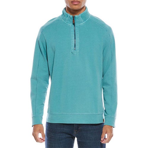 A turquoise quarter-zip pullover with long sleeves, featuring a high collar and visible stitching, paired with dark blue jeans.