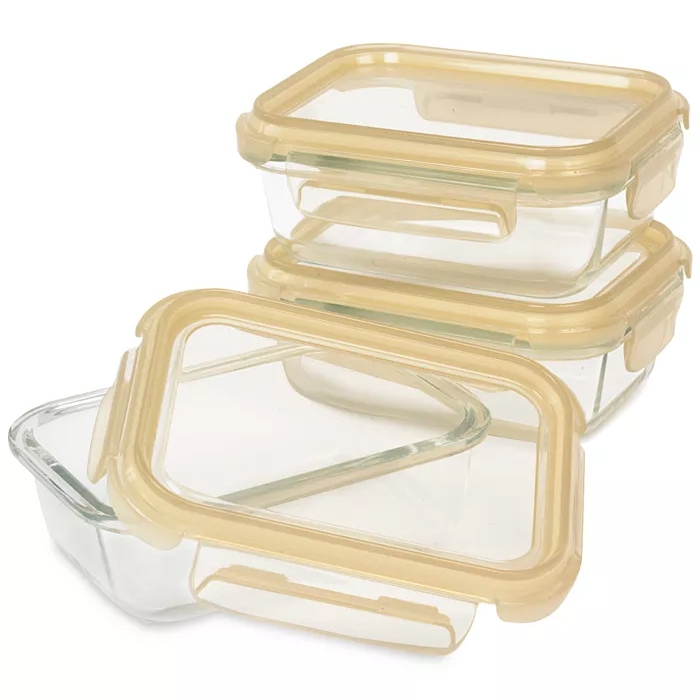 Three rectangular glass food storage containers with beige airtight lids are stacked, with one container open.