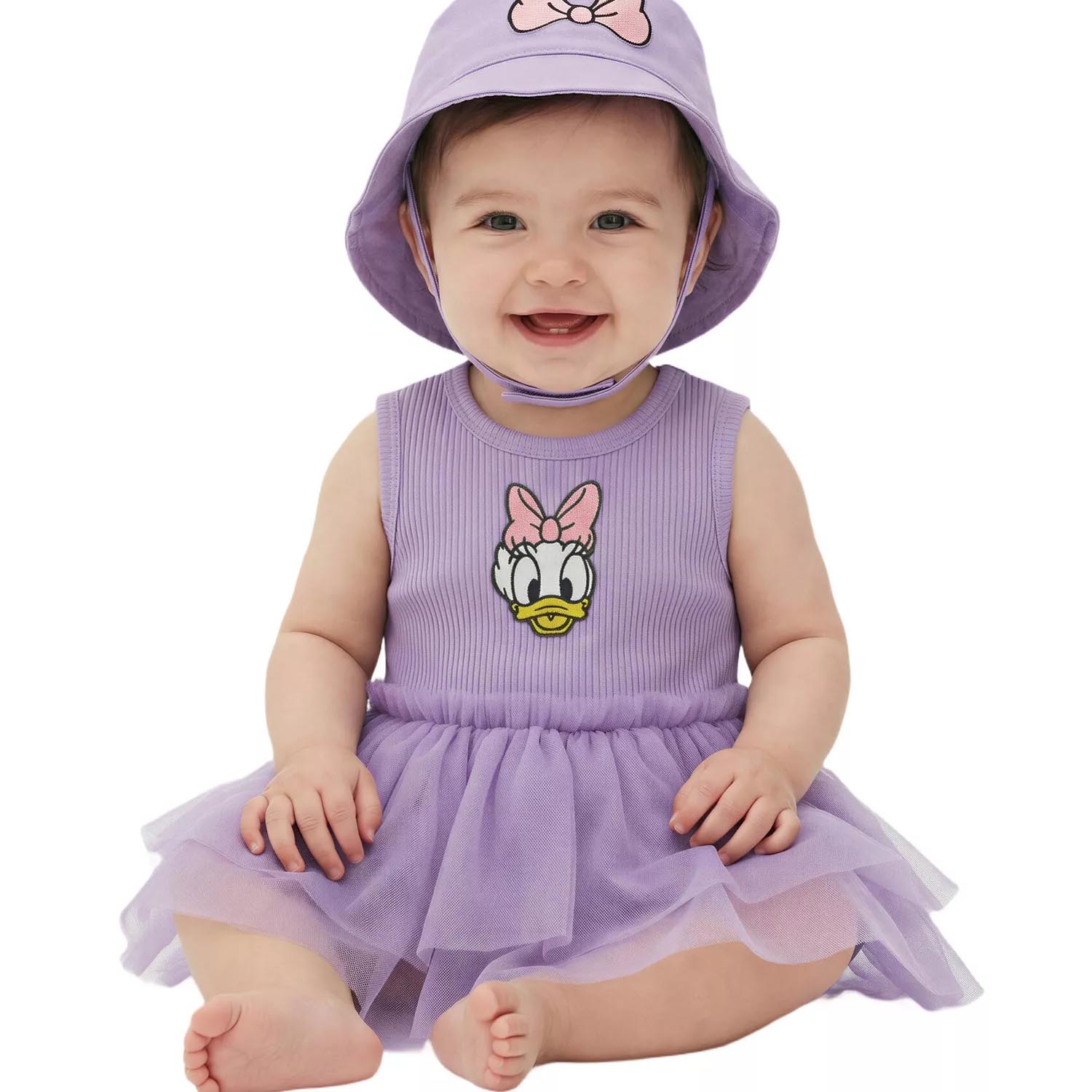 Baby wearing a purple dress with a Daisy Duck design and a matching sun hat featuring a bow.