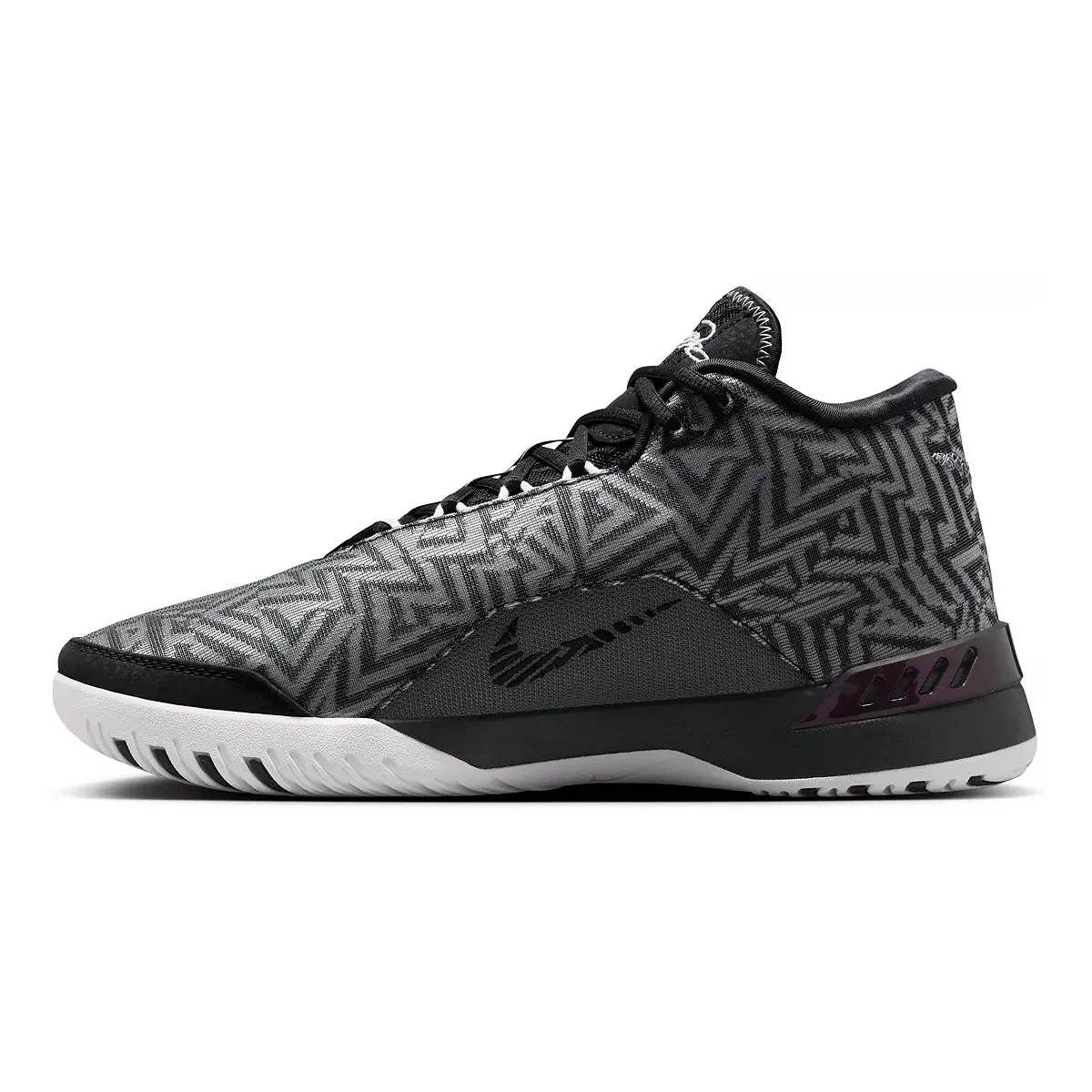 Nike LeBron NXXT Basketball Shoes feature a high-top design with a black and grey geometric pattern, black accents, and a white outsole for contrast. They include a stylized swoosh on the midfoot area.