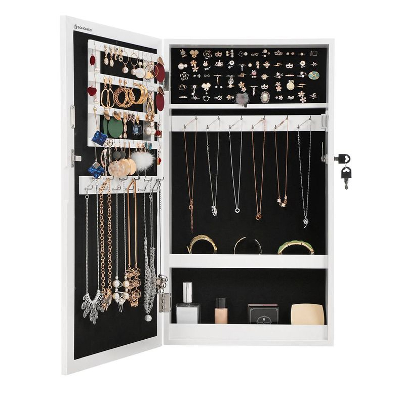 A wall-mounted mirror jewelry cabinet with a black interior organizes various accessories, including earrings, necklaces, bracelets, and rings. It has a locking mechanism with keys for added security.