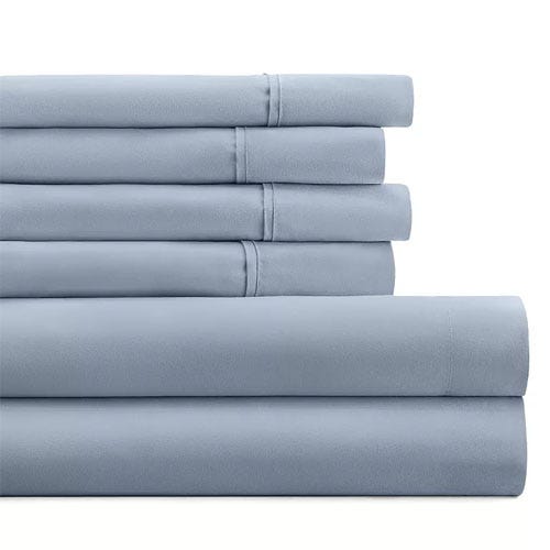 A neatly stacked set of blue bed sheets, including pillowcases and possibly flat and fitted sheets.