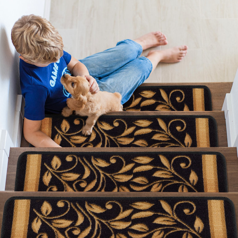 Set of 15 non-slip stair tread mats featuring a black and gold leaf pattern. Each tread fits standard stairs, enhancing safety and style with a decorative touch.
