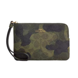 A camouflage-patterned wristlet with a logo on the front and a wrist strap.