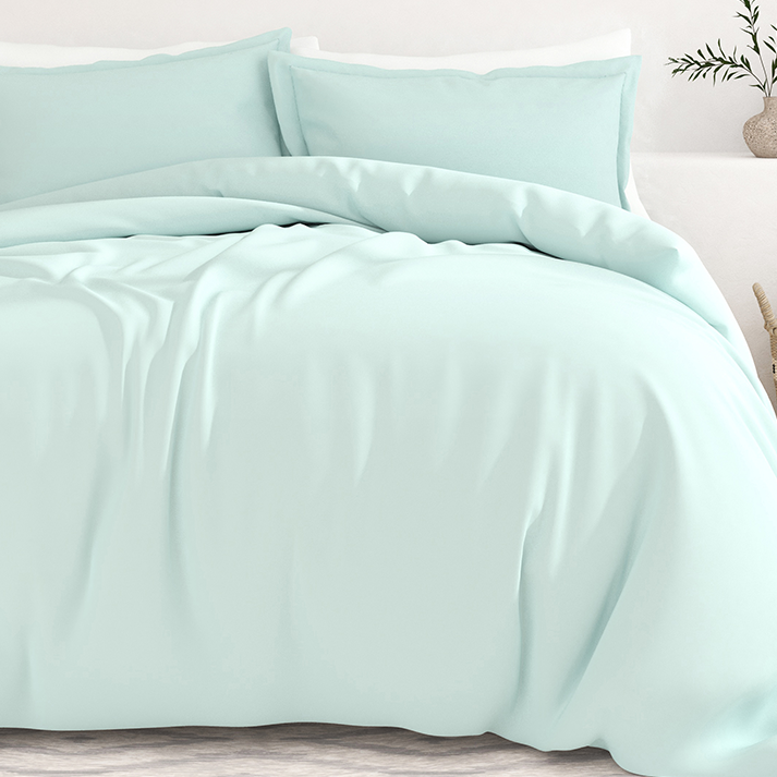 A mint green queen duvet cover set with two matching pillowcases, featuring a smooth and soft fabric texture, draped over a bed.