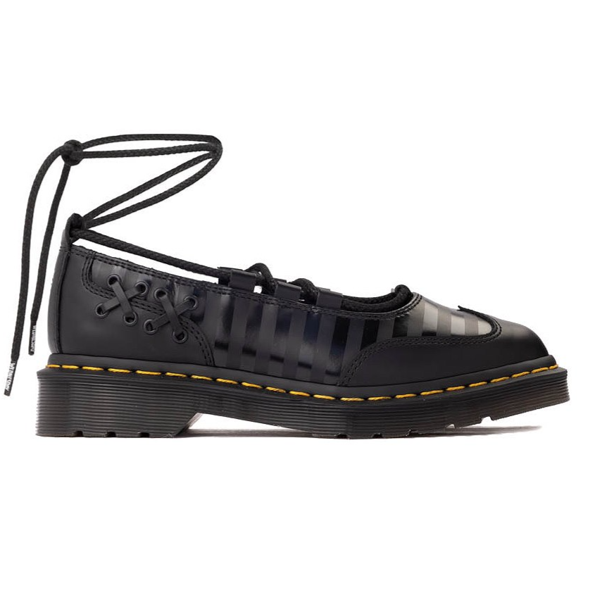 Black lace-up shoe with clear upper accents, featuring a thick sole with yellow stitching, and a unique ankle-tie design.