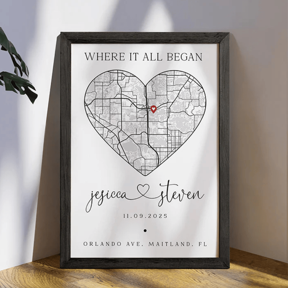 Framed map art with a heart shape featuring a location marker, personalized with the names \“Jessica\“ and \“Steven,\“ a date (11.09.2025), and the address \“Orlando Ave. Maitland, FL,\“ with the phrase \“Where It All Began.\“
