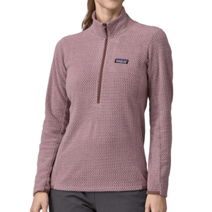 The Patagonia R1 Air Pullover is a women’s long-sleeve, half-zip fleece in a light purple color with a textured pattern. It features a stand-up collar and the Patagonia logo on the chest.