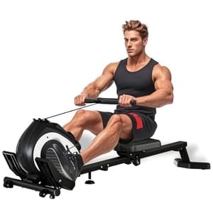 A man exercises on a magnetic rowing machine with a black and red seat, featuring a flywheel and footrests. The machine is designed for cardiovascular workouts and strength training.