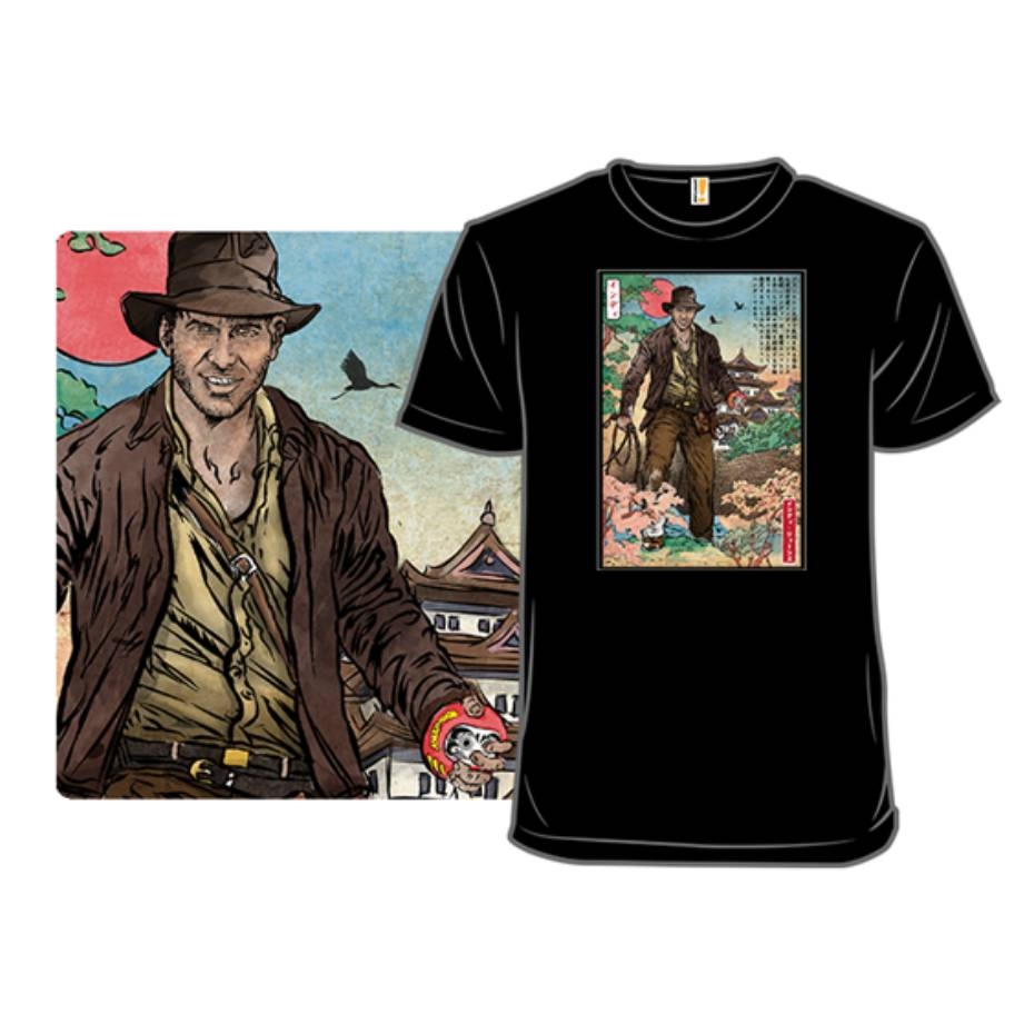 A black T-shirt features an illustration of a character resembling an adventurer in a Japanese setting, wearing a hat and coat, holding a whip, amidst traditional architecture and cherry blossoms.