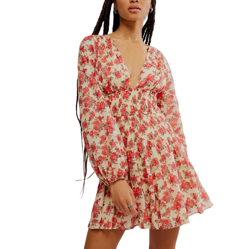 Floral-patterned cotton minidress with long sleeves, a deep V-neckline, and smocked waist and cuffs, featuring a flared skirt.