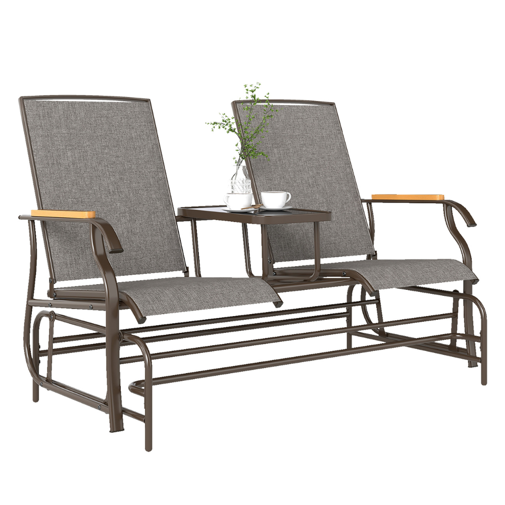 A two-seater outdoor glider bench with a middle table, featuring a metal frame, gray fabric seats, and wooden armrest accents.