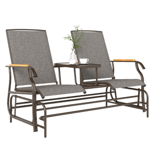 A two-seater outdoor glider bench with a middle table, featuring a metal frame, gray fabric seats, and wooden armrest accents.