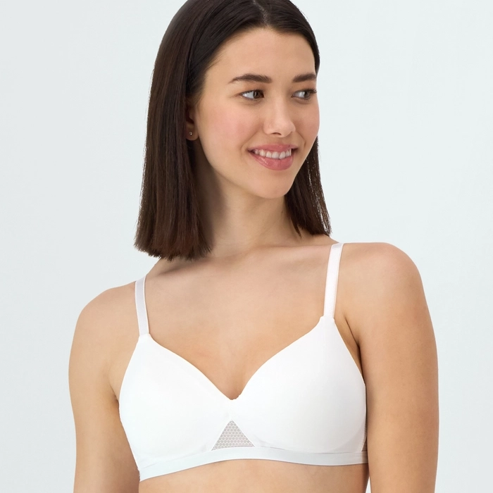 A woman is wearing a white bra with mesh detailing.