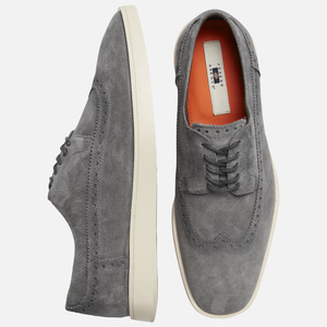 A pair of grey suede men's dress shoes with white soles.