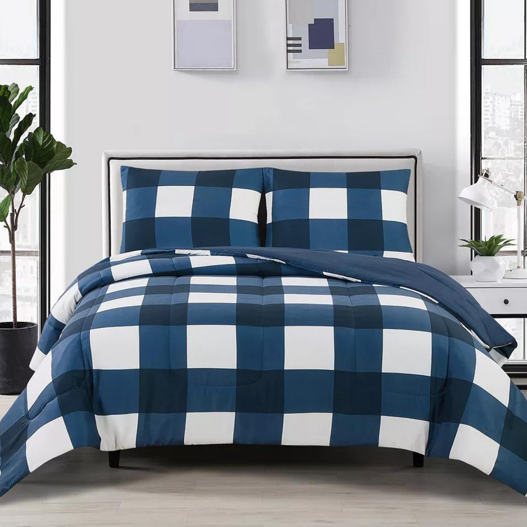 A navy blue and white checkered comforter set on a bed, with coordinating pillow shams.