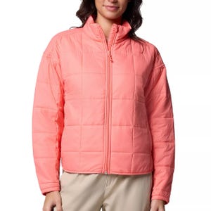 Coral pink quilted jacket with a front zipper, high collar, and long sleeves, paired with beige pants.