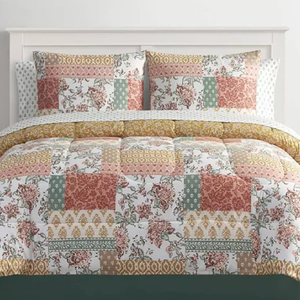 This is an 8-piece comforter set featuring a patchwork design of various patterns in shades of red, gold, and green, with two pillow shams and coordinating decorative pillows.