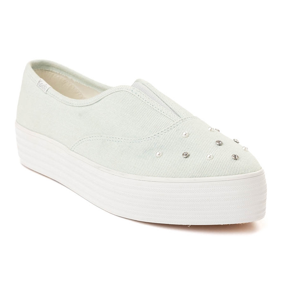 The Keds Point Slip Denim Platform Sneaker features a light green denim upper with silver embellishments and a thick white platform sole, combining casual comfort with stylish details.