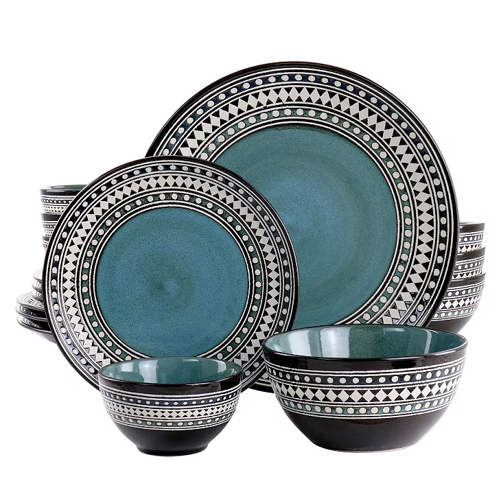 A set of ceramic dinnerware with a teal center and black and white geometric patterns along the rims.