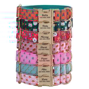 A collection of colorful pet collars with various festive and playful designs, each featuring a customizable nameplate and contact number.