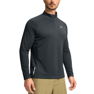 A man wears a dark long-sleeve quarter-zip athletic top, paired with light khaki pants.