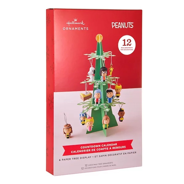 Hallmark Ornaments Peanuts Countdown Calendar with 12 mini character ornaments and a paper tree display, featuring designs from the Peanuts series.