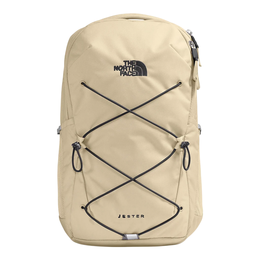 A beige North Face Jester backpack featuring a front bungee cord system, zippered compartments, and side mesh pockets.
