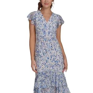 A woman wearing a knee-length, short-sleeve, floral-print dress with a V-neck and tiered ruffles in blue and white tones.