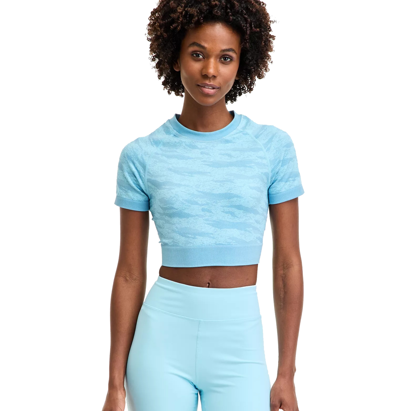 A person is wearing a light blue cropped short-sleeve top with a subtle pattern and matching blue leggings.