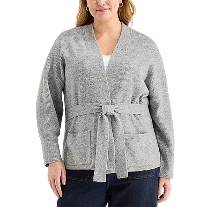 A woman is wearing a gray, belted cardigan with long sleeves and front pockets, paired with dark pants.