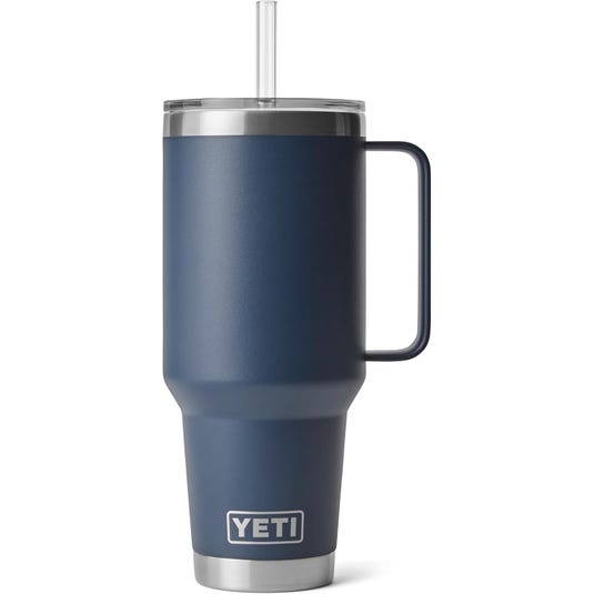 A blue YETI travel mug with a handle, featuring a clear lid and a straw.