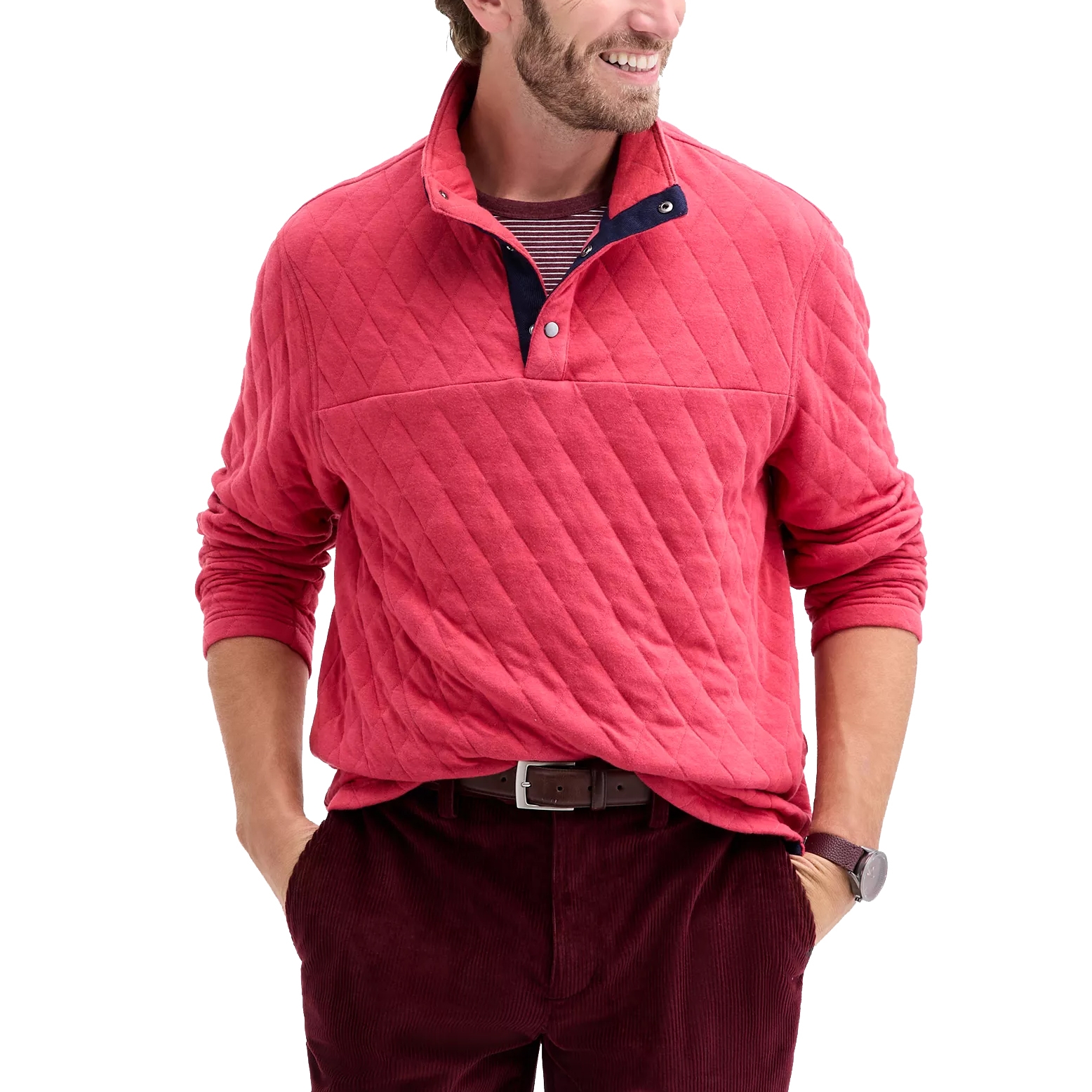 A man is wearing a red quilted pullover with a striped undershirt, brown belt, and burgundy corduroy pants, accessorized with a watch.
