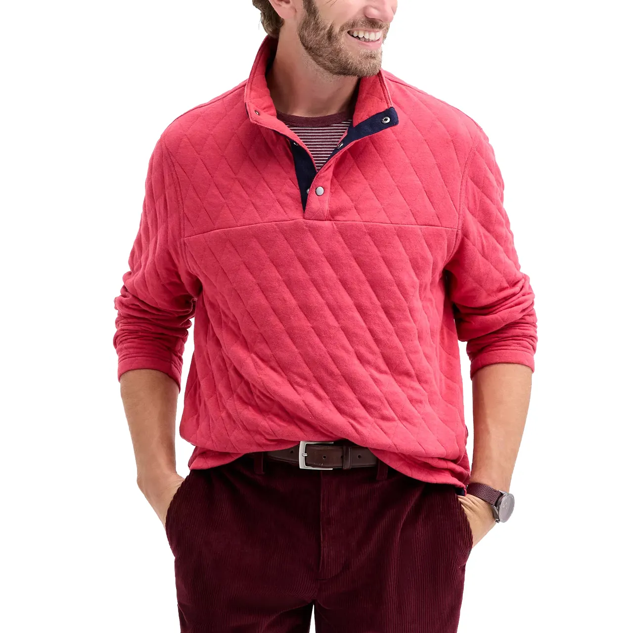 A man is wearing a red quilted pullover with a striped undershirt, brown belt, and burgundy corduroy pants, accessorized with a watch.