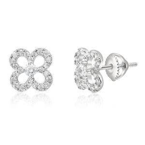 A pair of silver stud earrings with a four-leaf clover design, enhanced by small round-cut gemstones and featuring a screw-back closure.