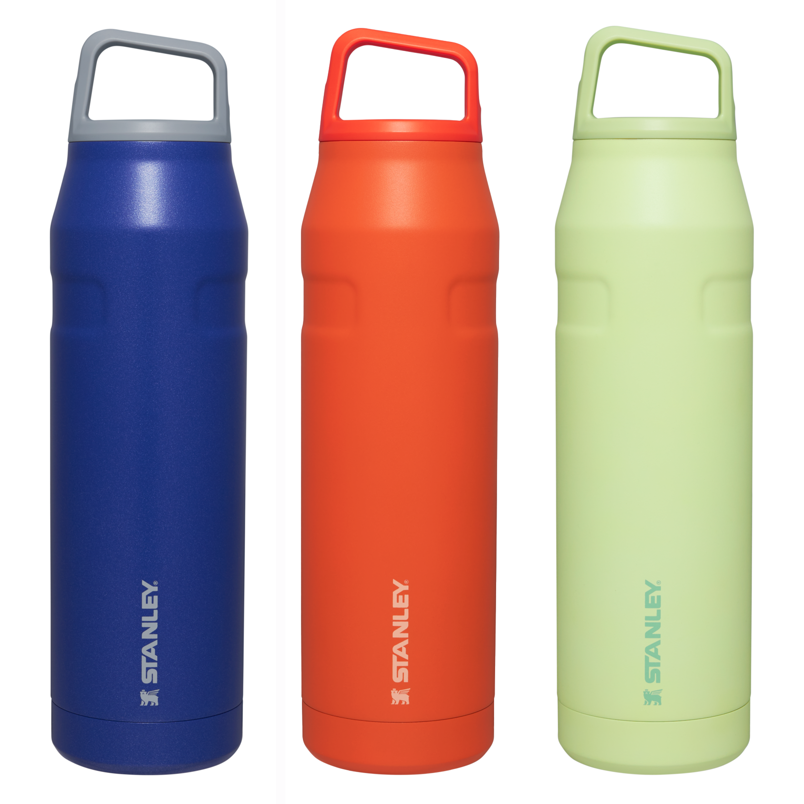 Three Stanley insulated water bottles in blue, orange, and green, each with a handle on the lid.